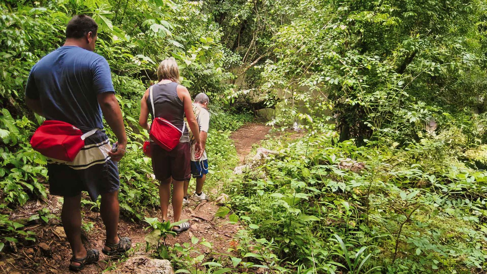Hiking in the tropical forest during the ATM Caves Tour in Belize.