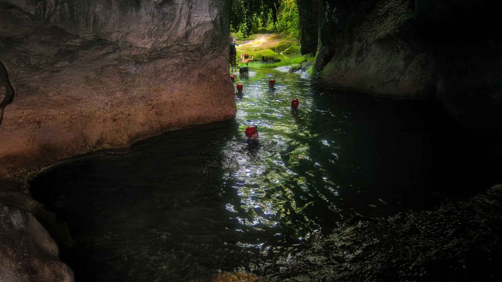 Happy tour group exiting the Actun Tunichil Muknal cave after a guided adventure tour in Belize.