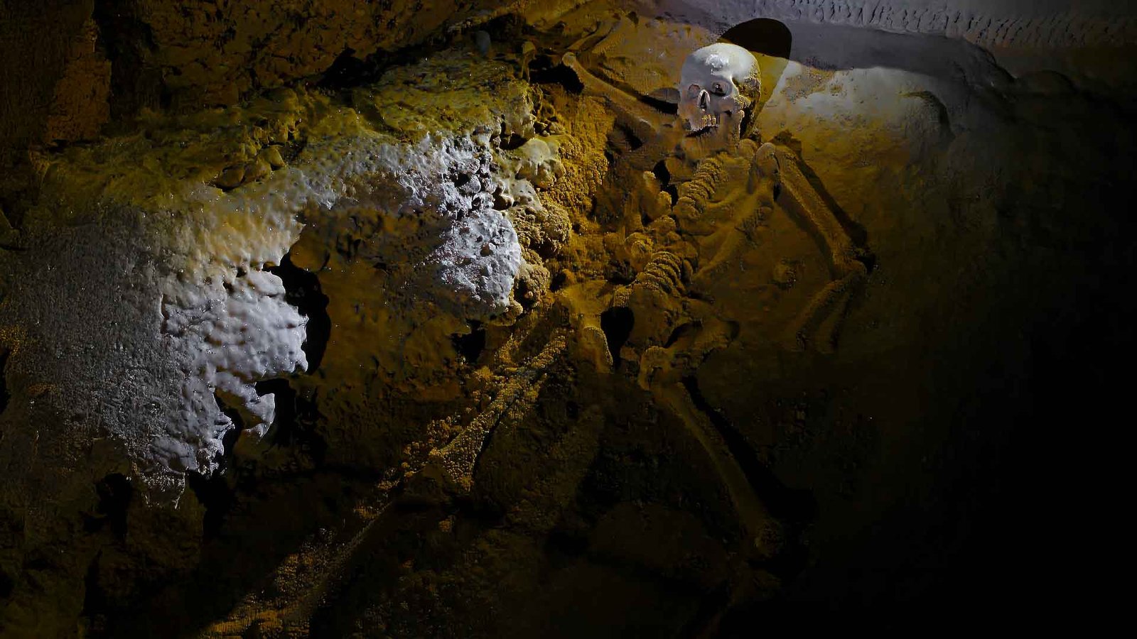 The Crystal Maiden skeleton in Actun Tunichil Muknal cave, a calcified Maya sacrifice seen on the Actun Tunichil Muknal tour in Belize.