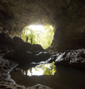 Couple exploring a sacred Maya cave near San Ignacio, an adventurous highlight of a Belize family holiday.
