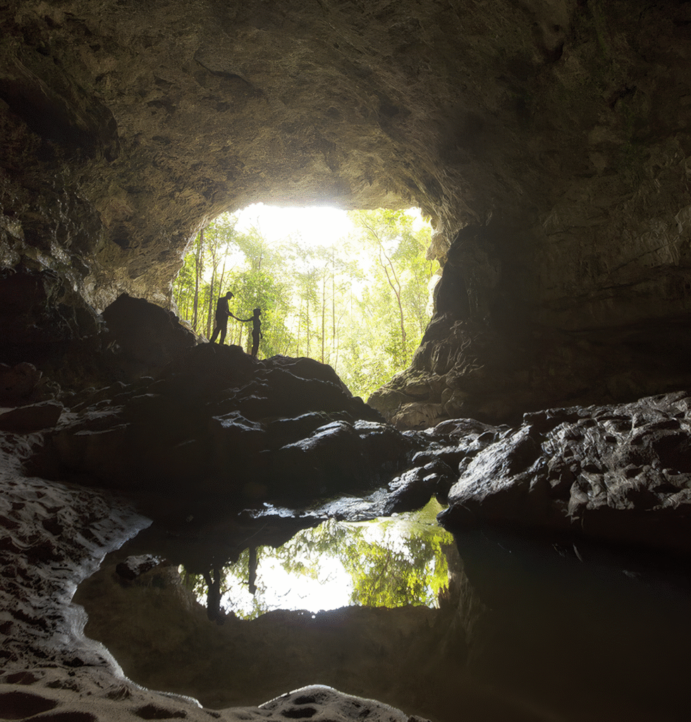 Couple exploring a sacred Maya cave near San Ignacio, an adventurous highlight of a Belize family holiday.