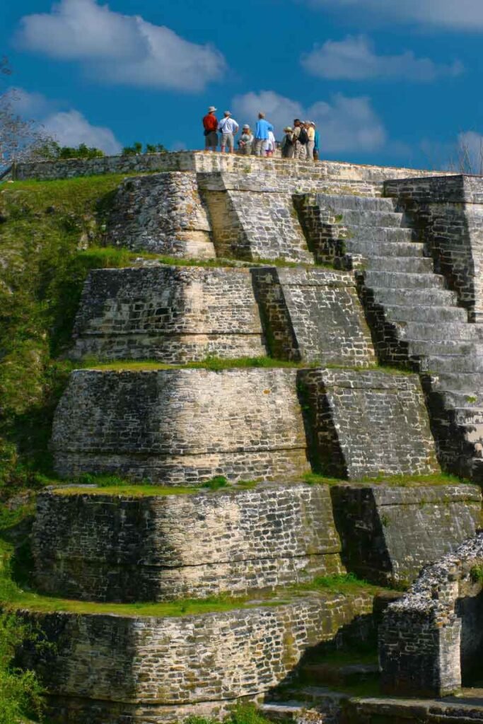 Visitors exploring the iconic Temple of the Masonry Altars at Altun Ha, one of Belize’s most famous Maya archaeological sites.