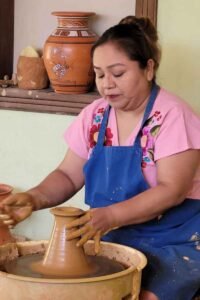 San Antonio Belize Maya cooking and pottery tour — Maya woman demonstrating traditional ceramic-making techniques to guests at the San Antonio Women’s Cooperative.