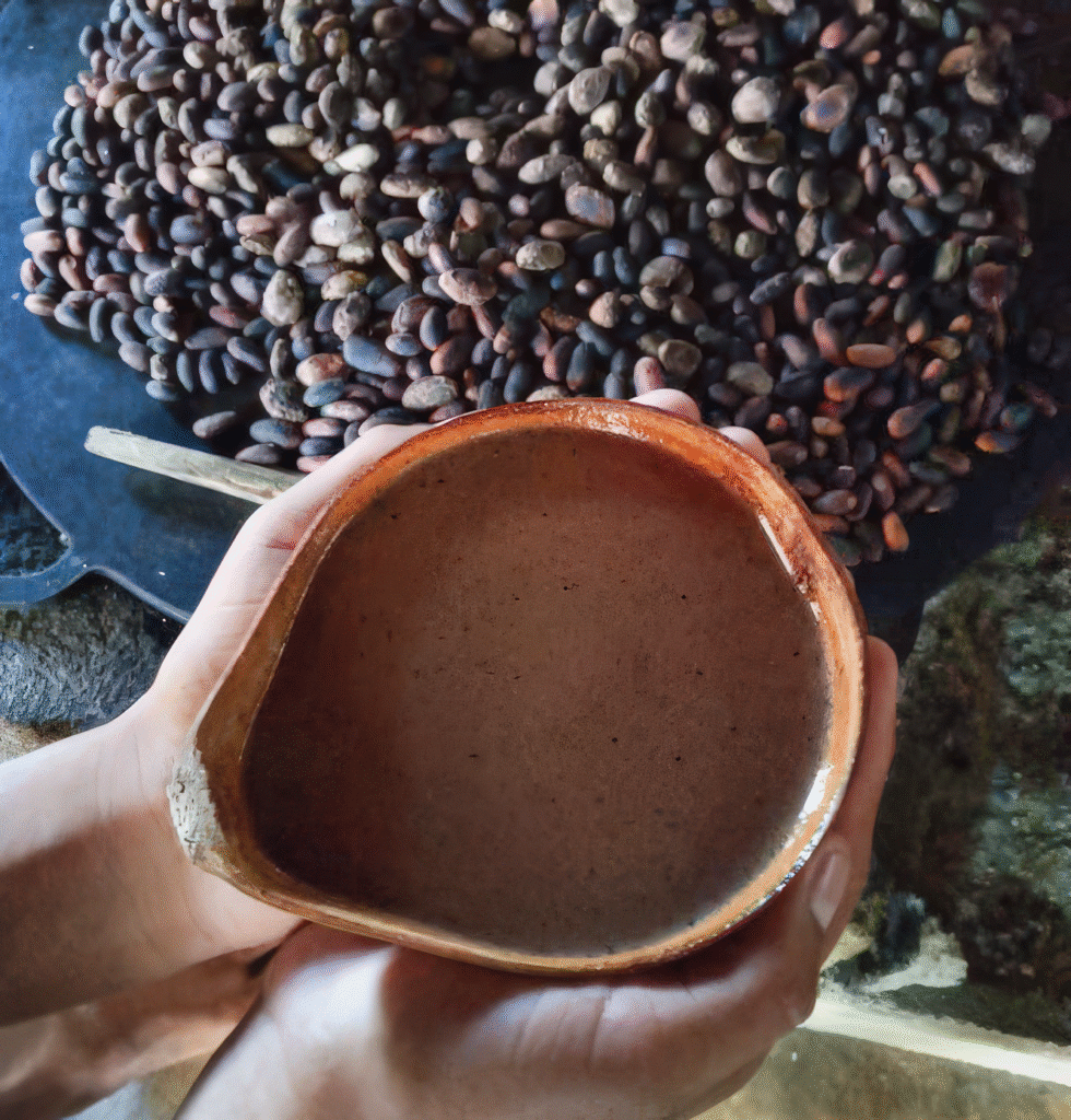 Hand holding a traditional Maya chocolate drink during a workshop in San Ignacio, an authentic cultural experience on a Belize Family Vacation.