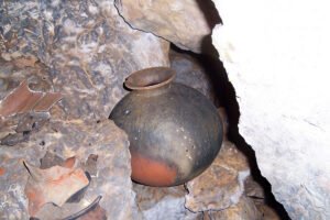 Ancient Maya ceramic pot inside Crystal Cave, captured during the Crystal Cave Day Tour Belize, showcasing the cave’s archaeological significance and ritual history.
