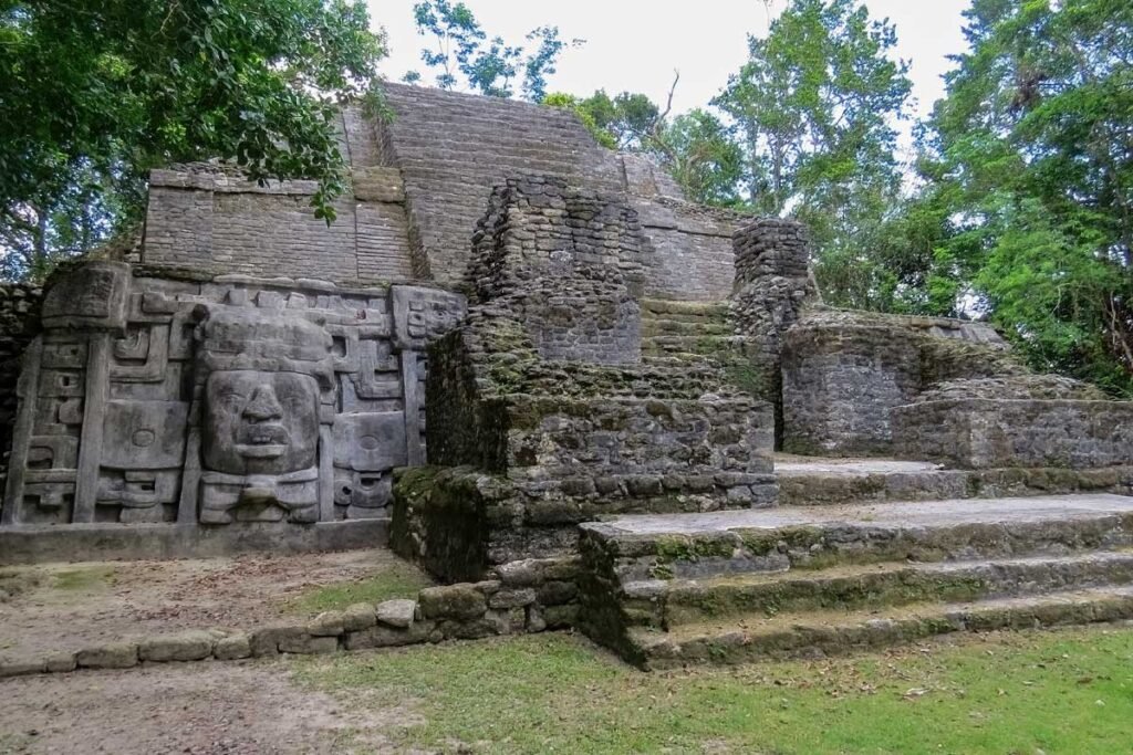 Ancient Lamanai Maya temple rising above the jungle canopy in Belize, featured on a Belize Tikal ruins exploration tour.