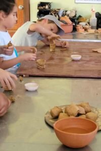 A group ok kids having fun during the pottery workshop in San Ignacio, Belize.