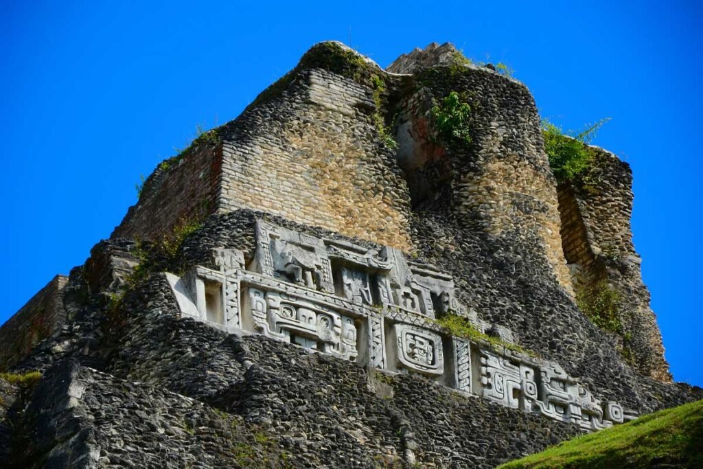 Close-up of intricate Maya carvings on the facade of El Castillo during the Xunantunich Mayan Ruins Tour.