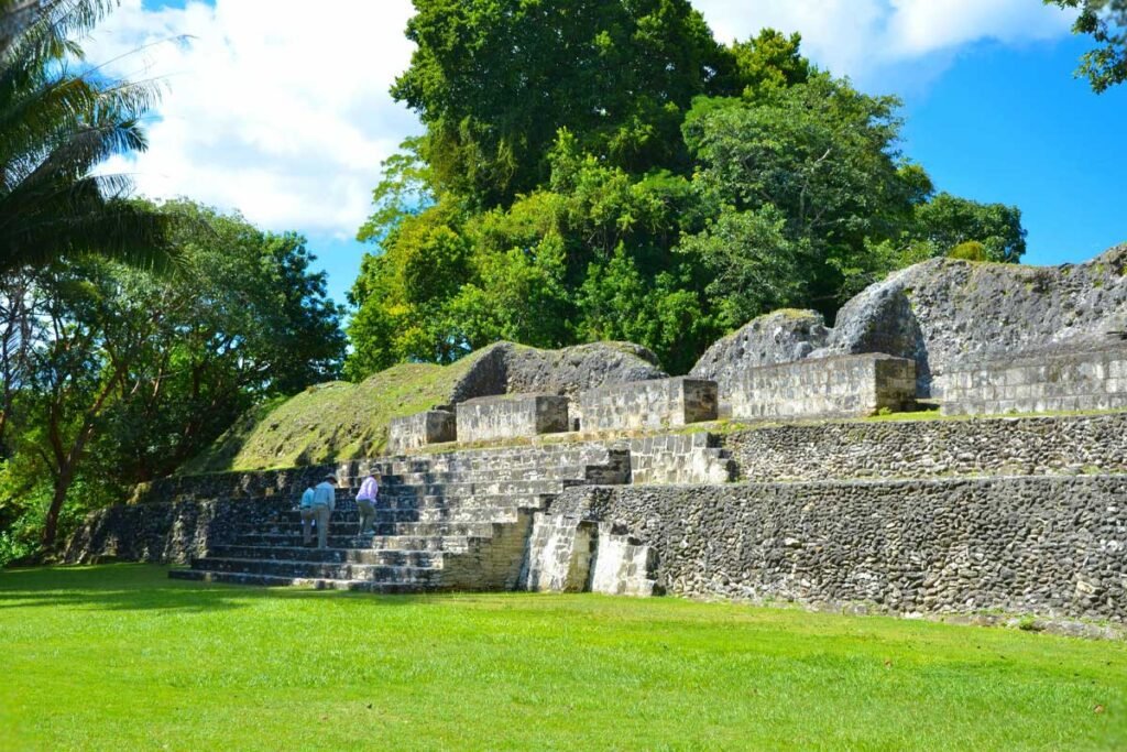 Visitors exploring ancient stone structures at the Xunantunich Mayan Ruins Tour in western Belize. Historic carvings and stelae at Xunantunich captured during a guided Xunantunich Mayan Ruins Tour.