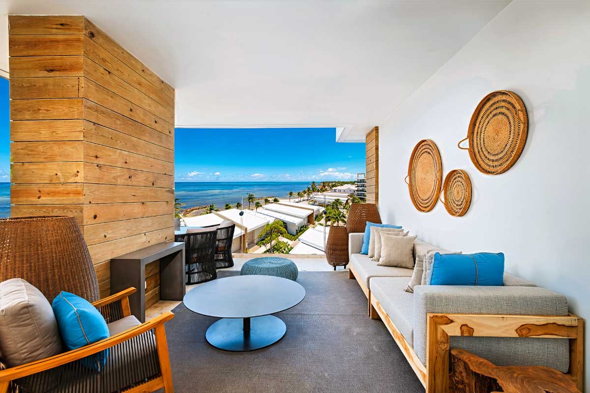 Open-concept living room at Alaia Belize with panoramic Caribbean Sea views, showcasing luxury design and comfort at one of the best all-inclusive resorts in Ambergris Caye.