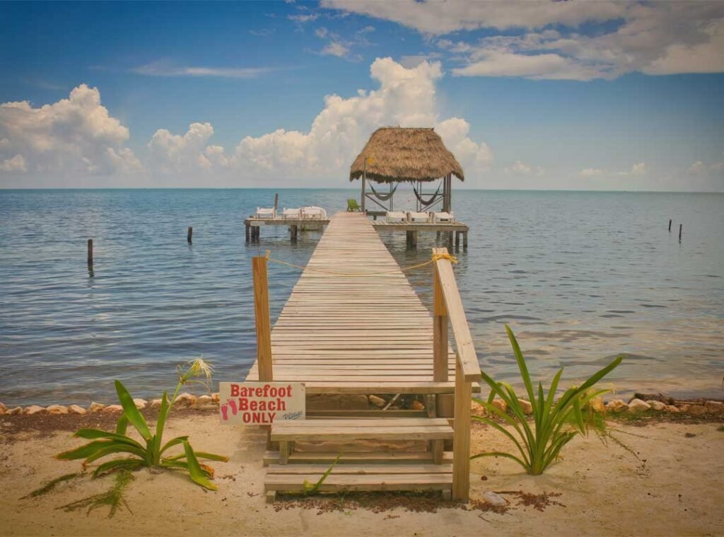 Wooden deck extending into the Caribbean Sea on Caye Caulker Island, Belize, capturing the island’s laid-back charm and coastal beauty.