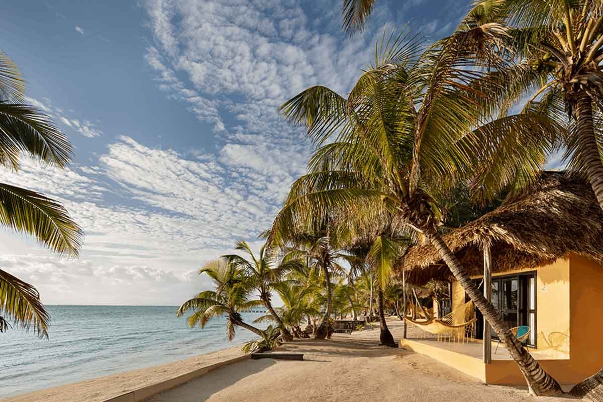 Seafront cabana at Matachica Resort with ocean views and thatched roof — one of the best all-inclusive resorts in Ambergris Caye for couples.