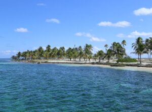 Half Moon Caye in Atolls and Outer Cayes, Belize, with white sand beach, turquoise waters, and red-footed booby bird habitat