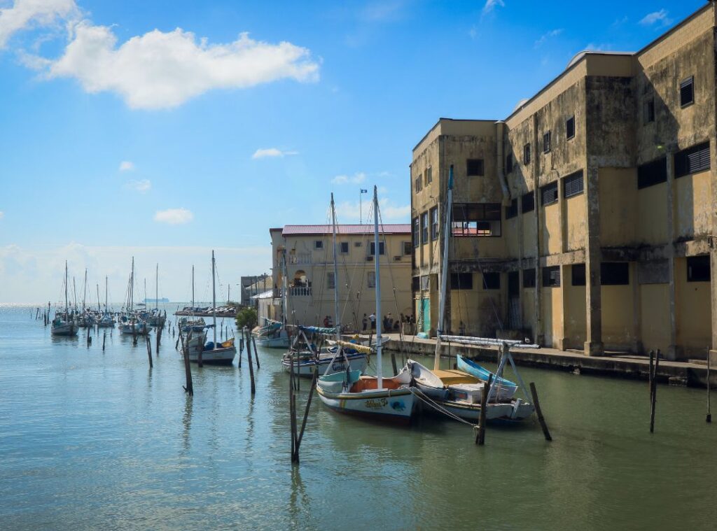 Belize City’s Haulover Creek with boats docked along the waterfront and colonial buildings in the background