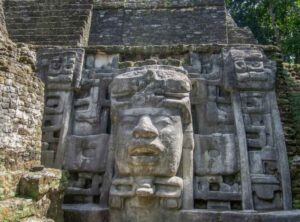 Lamanai Maya ruins near Orange Walk Belize. This picture exposes public art through masks in the buildings