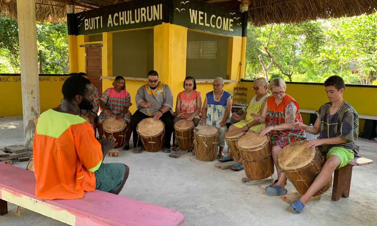 Family-Travel-Belize Belize Family Vacations with a mother and young boy enjoying a respectful Garifuna drumming session in Hopkins, Belize.