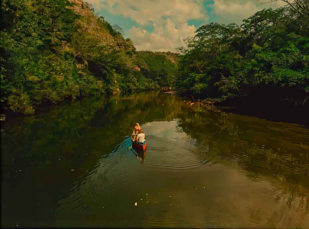 Macal-River-Adventure - Authentic Travel Belize Canoe on the Macal River near San Ignacio, Belize, a peaceful jungle adventure in western Belize