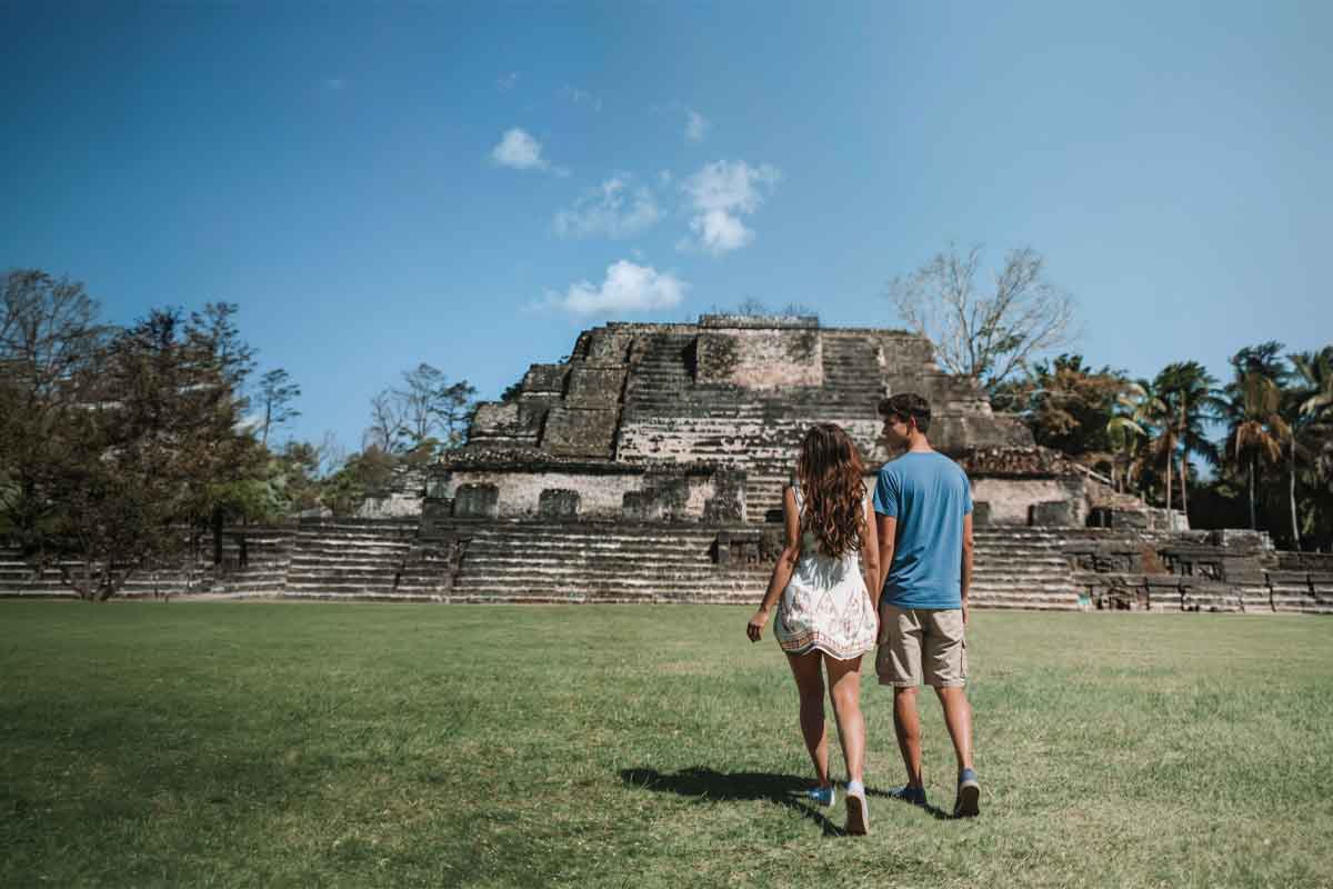 Private Archaeological Experiences Couple visiting a Maya archaeological site with private guiding during a Belize luxury and boutique travel journey.
